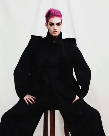 Model with vibrant pink hair that creates a bold statement, while textured spikes add a punk-inspired edge.