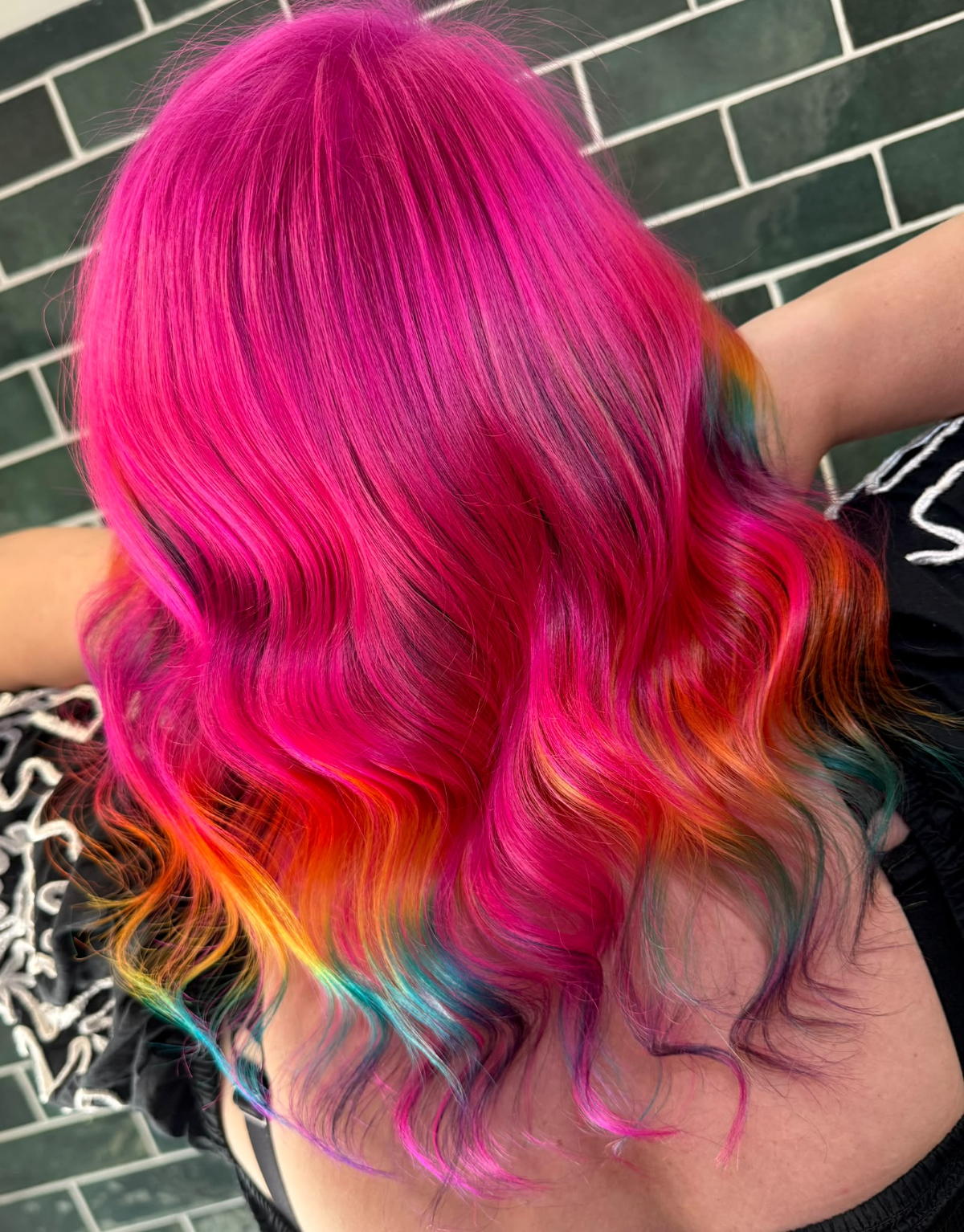 Model with vibrant pink look with a rainbow peekaboo panel underneath.