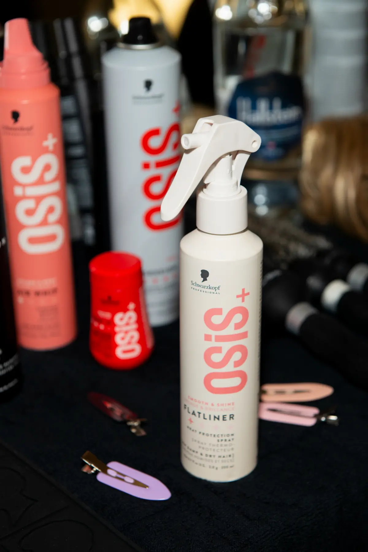 SKP OSIS spray bottle on a dressing table back stage at PFW SS27.