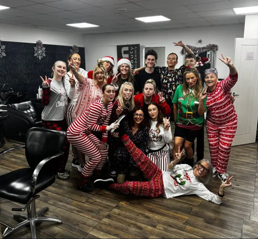 Staff in a salon dress in christamas pjamas with Marlene Lamont.