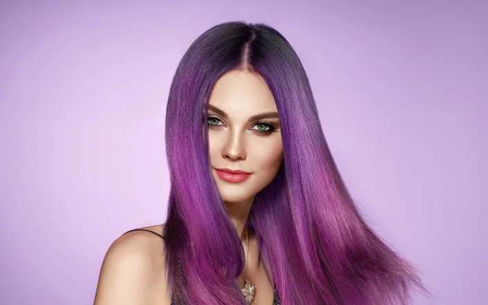 A model with purple hair on a purple background